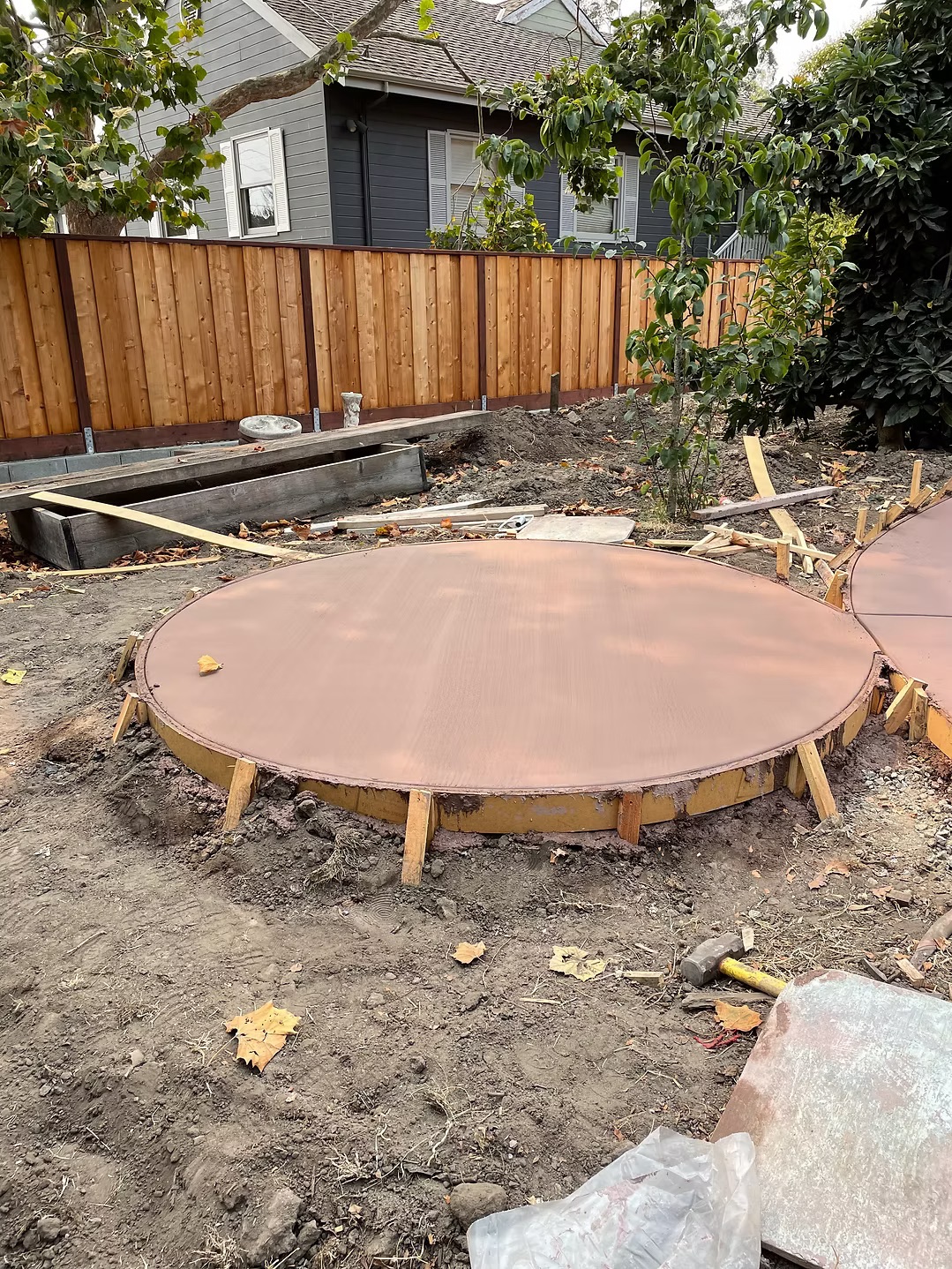 Circular concrete patio slab poured with wood forming still in place